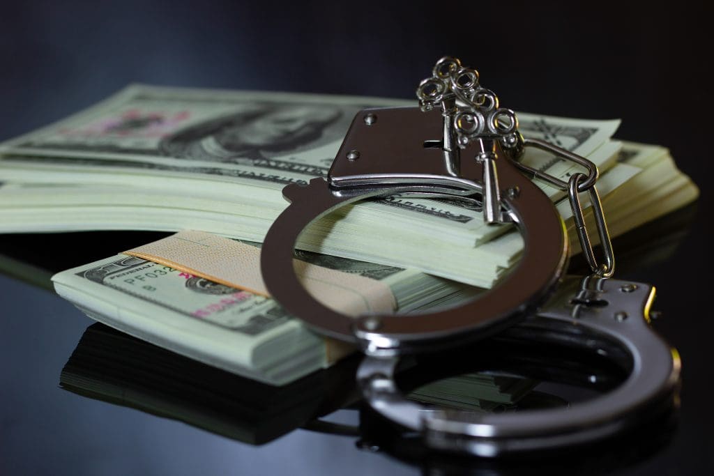 handcuffs on a stack of money for bail.